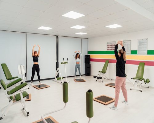 Group of diverse people practicing dynamic functional exercises in a bright fitness room