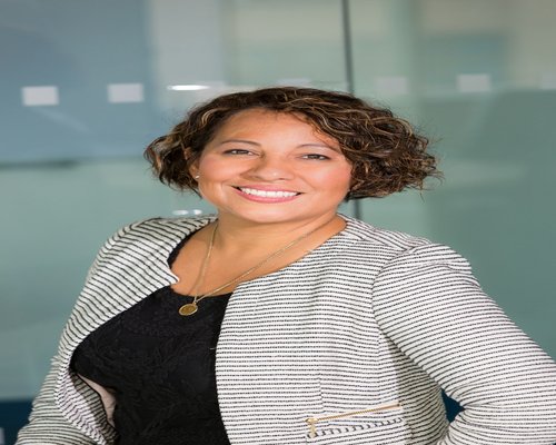 Portrait of Andrea R., fitness coach focused on cardiovascular endurance and office mobility