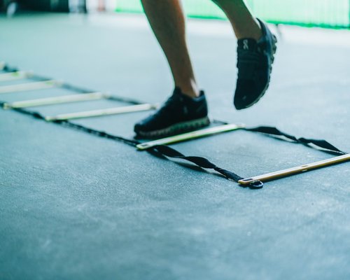 High energy group training setting with agility ladders and light workout steps